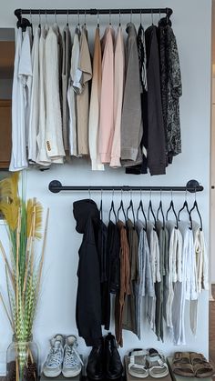 a rack with shoes and clothes hanging on it