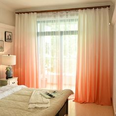 a bedroom with an orange and white color scheme on the walls, curtains, and bedding