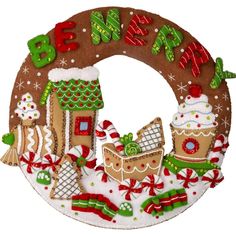 a decorated christmas wreath with gingerbreads and houses