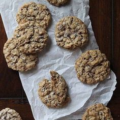 chocolate chip cookies sitting on top of a piece of paper