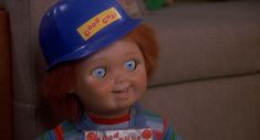 the doll is wearing a blue hard hat