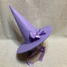 UPDATE: AUGUST 2023- These hats are now made with two layers of felt in the cone.  The double layer makes for a stronger hat which stands up on its own while still being light enough to be comfortable. Looking for a fun witch hat?  Who says that witches have to wear black?  Want to look like you stepped out of the pages of a fairy tale?  Searching for a unique hat for Halloween?  This is perfect for the practical witch who wants her hat to stay put while she soars through the night sky on her broomstick. These witch hats are made out of soft wisteria purple wool/rayon felt.  Satin ribbons tie under your chin.  Choose from a plain hat or one decorated with a matching satin bow pin.   Wool Felt is a blend of 35% wool and 65% rayon.  It's a very soft, flexible fabric which makes a lightweight Cool Witch Hats, Purple Witch Hat, Wisteria Purple, Purple Witch, Smiling Friends, Purple Hat, Witch Hats, Unique Hats, Satin Ribbons