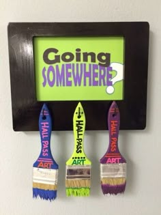 three paintbrushes are hanging on a wall with the words going somewhere painted on them