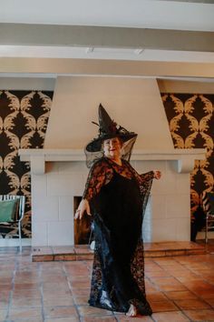 a woman in a witch costume standing on the floor