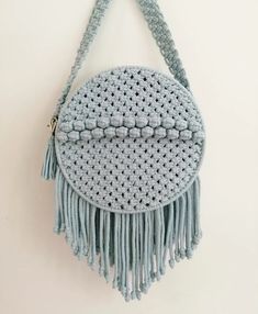 a crocheted purse hanging on the wall