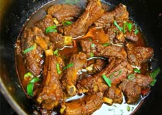 beef and peppers in a skillet being cooked