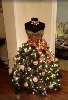 a mannequin dressed up as a christmas tree with lights and ornaments on it