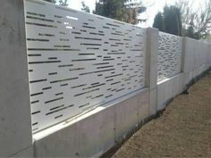 a white fence that is next to some dirt