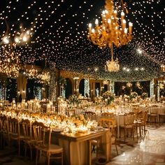 a banquet hall with tables and chairs covered in lights