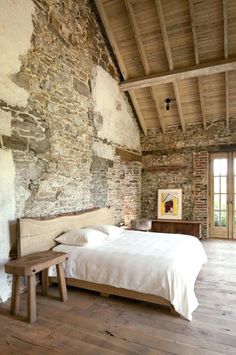 a bed sitting in a bedroom next to a wooden bench