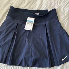 Nwt Nike Tennis Skirt In Navy. Size Medium. Has Built In Shorts With A Pocket. Navy Pleated Tennis Skirt, Nike Stretch Lined Skirt Bottoms, Nike Lined Skirt For Spring, Navy Casual Pleated Skirt Bottoms, Nike Short Lined Skirt, Nike Spring Pleated Skirt, Nike Fitted Skirt, Nike Pleated Skirt Fitted Bottoms, Nike Casual Skirt Bottoms