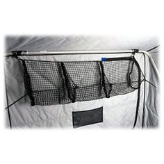 the net is hanging on the wall with three pockets for fishing nets and two hooks