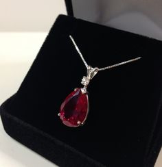 "Beautiful Ruby & White Sapphire Pendant Necklace  * 7.5ct Pear Cut Ruby Measures 15mm x 10mm   * Single Brilliant Cut White Sapphire Accent   * 18\" Sterling Silver Chain Included  * Solid Sterling Silver - Also available in 14kt Gold (message me for details) Hallmarked & Gift Ready!  Matching Earrings & Ring Available This Gorgeous 7.5ct Ruby is laboratory grown.  It is identical to the natural stone in every way, including chemistry, composition and hardness, with an outstanding cut, clarity Sapphire Necklace Pendants, Ruby Pendant, Fine Art Jewelry, Ruby Necklace, Rose Gold Pendant, Sapphire Pendant, Ruby Jewelry, Girly Jewelry, Diamond Pendant Necklace