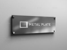 a metal plate mounted on the wall with an inscription that says metal plate in white