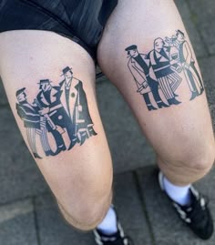 two people with tattoos on their legs