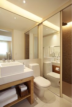 a bathroom with a sink, toilet and shower in it's own area is shown