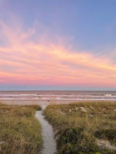 a path leading to the beach at sunset