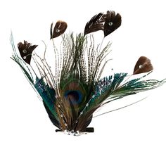 a vase filled with lots of feathers on top of a table