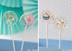 there are three lollipops with different designs on them