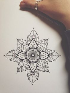 a drawing of a flower in black and white with an intricate design on the paper