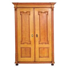 an old wooden armoire with two doors on the top and bottom, against a white background