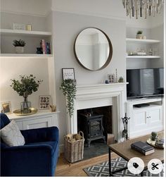 a living room filled with furniture and a fire place in front of a flat screen tv