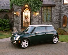 a green car parked in front of a house