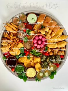 a platter filled with lots of different types of food and condiments on it