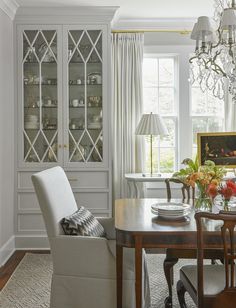 a dining room table with chairs and a china cabinet