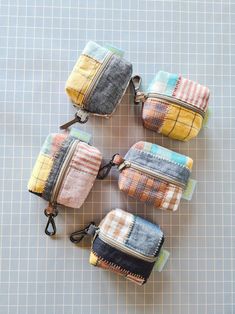 four small zippered pouches sitting on top of a table