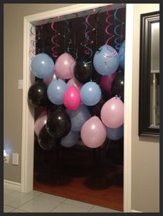 balloons and streamers are hanging from the door