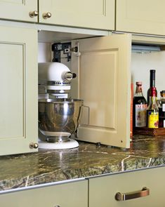 a kitchen counter with a mixer in it