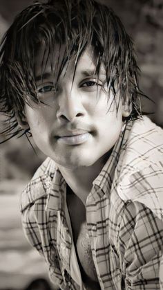 black and white photograph of a young man with wet hair on his head, looking at the camera