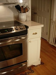 a kitchen with an oven, stove and counter space in the center is shown here