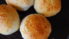 four rolls sitting on top of a black grill