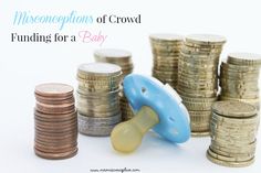 a blue pacifier sitting on top of stacks of coins next to piles of coins