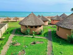 an aerial view of some huts near the ocean