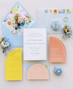 the wedding stationery is laid out neatly on top of each other, including an envelope and ring