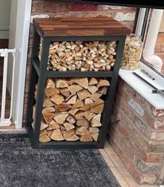 a stack of firewood sitting on top of a wooden floor next to a window