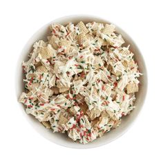 a white bowl filled with christmas sprinkles and crackers on top of it