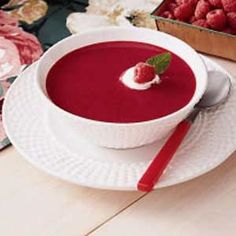 a bowl of raspberry soup on a white plate