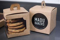 there is a box with some cookies in it and the packaging has a sticker that says madu bakers