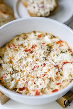 a white bowl filled with food on top of a table