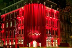 a large red building with lights on it's sides and the word center lit up at night