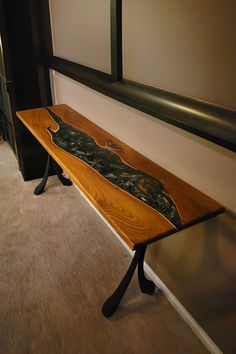 a wooden bench sitting on top of a carpeted floor