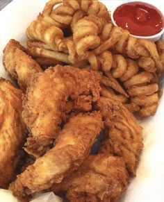 fried chicken and onion rings with ketchup on the side