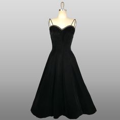 ~ 1950s midnight black velvet fit and flare dress by Jonny Herbert.  ~Sweetheart neckline trimmed in curved lattice ribbon.  ~Double ribbon cord straps ~ Darting on the bust and built in boning on the bodice.  ~ Fitted waist with a very full skirt. ~ One hidden hip pocket.   ~ Back metal zipper for closure. ~ Dress was photographed with a petticoat (not included) .   Size - Small Bust - 34" Waist - 25 1/2" Hip - free  Length - 45.5" Label: Jonny Herbert  Condition: excellent vintage condition. 1950s Cocktail Dress, 1950s Party Dresses, 1950s Party, Black Velvet Dress, 1950s Dress, Dress Clothes For Women, Velvet Dress, Fit And Flare Dress, Petticoat