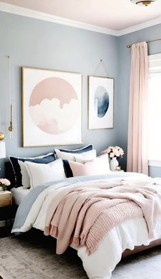 a bedroom with blue walls and white bedding, two paintings hanging on the wall