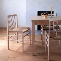 two wooden chairs sitting next to each other on top of a hard wood floor