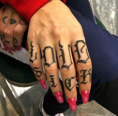 a woman's hand with tattoos on it and the word love written in cursive writing